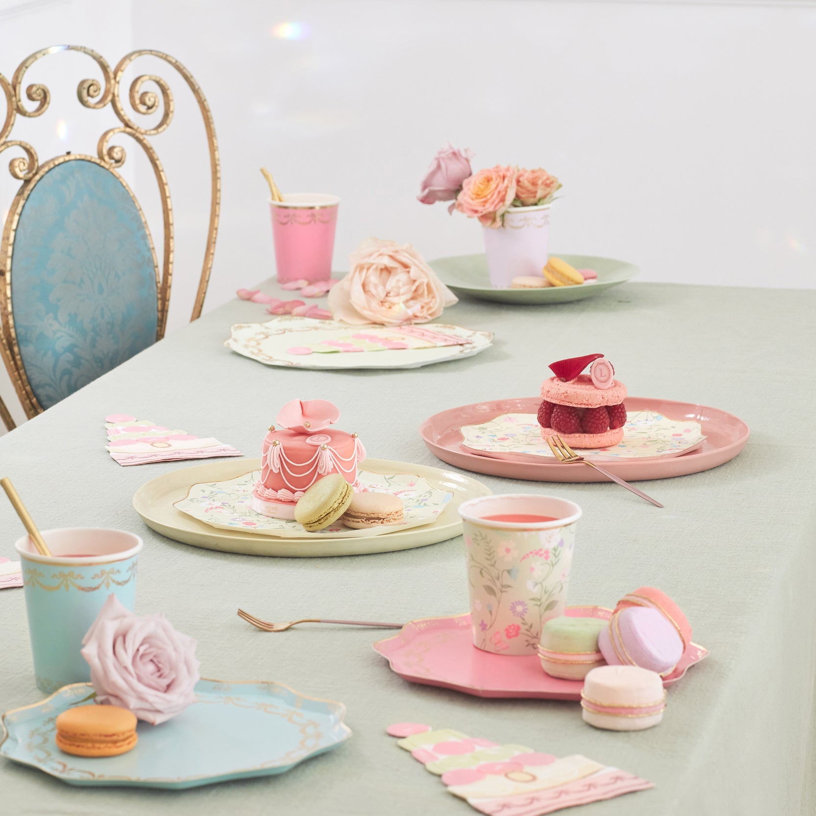 A table set with Ladurée Paris cups and desserts, creating a collaborative display reminiscent of a Meri Meri setting.