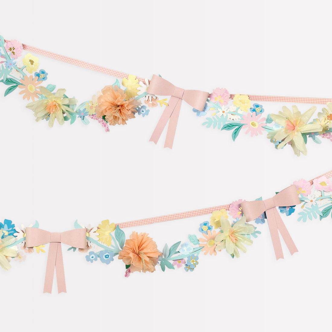 A Meri Meri Flower &amp; Bow Garland adorned with delicate pink flowers and charming bows.