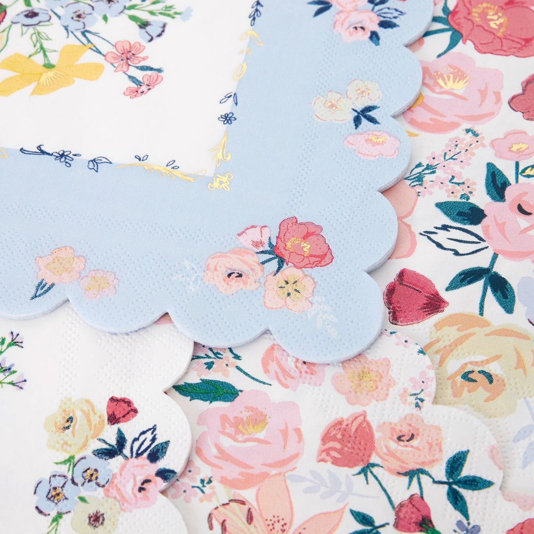 A set of Meri Meri English Garden Napkins with floral designs, perfect for a party table.