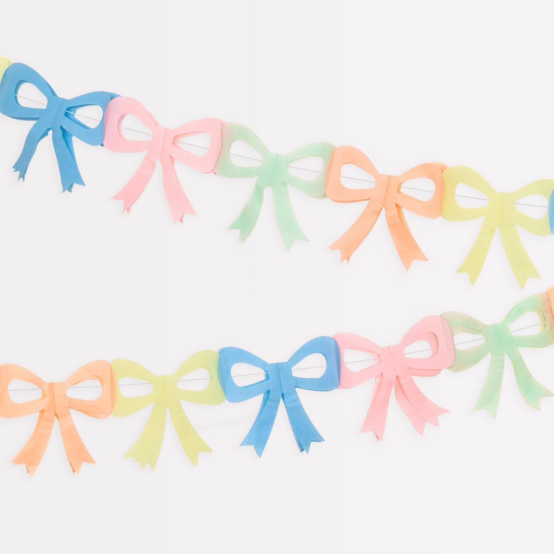 Colorful Meri Meri tissue paper bow garland on a white background.