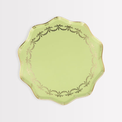 A lime green plate with gold trim and Meri Meri Ladurée Paris Paper Plates.