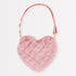 A pink Meri Meri plush heart-shaped bag with a red strap.