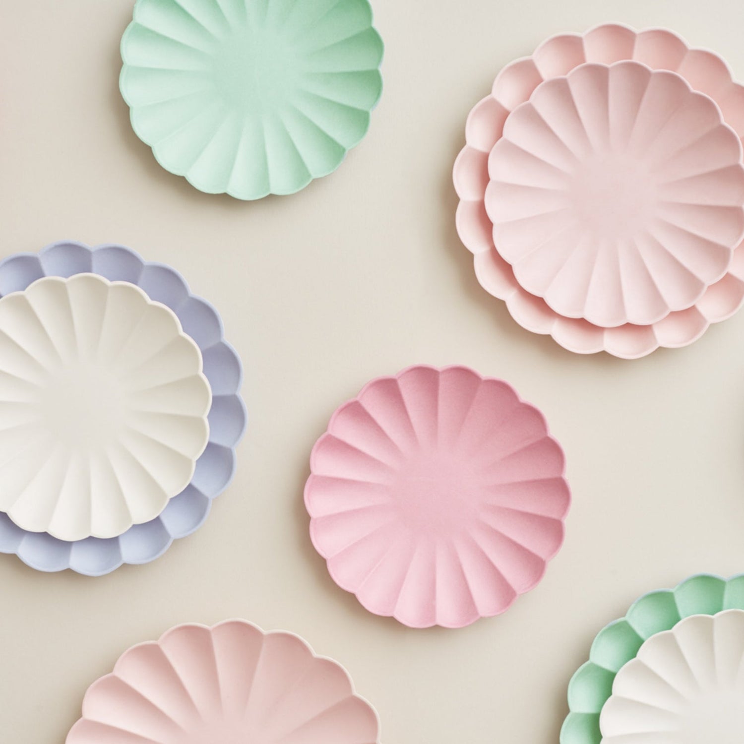 Meri Meri Cream Eco plates in pastel colors on a white background.