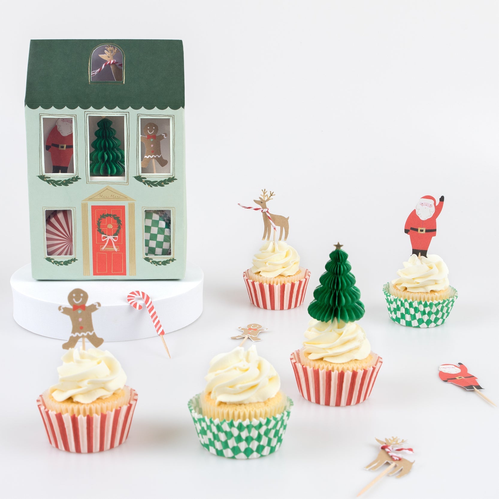 5 cupcakes with toppers and house  shaped box in background