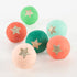 6 plastic surprise balls wrapped in 6 colors of crepe paper - dark red, dark green, mint, coral, pink and green