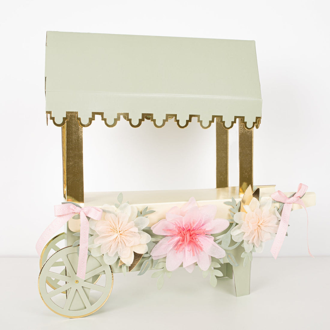 A pink and green Meri Meri Laduree Paris Macaron Cart Centerpiece with flowers on it, used for a macaron display.