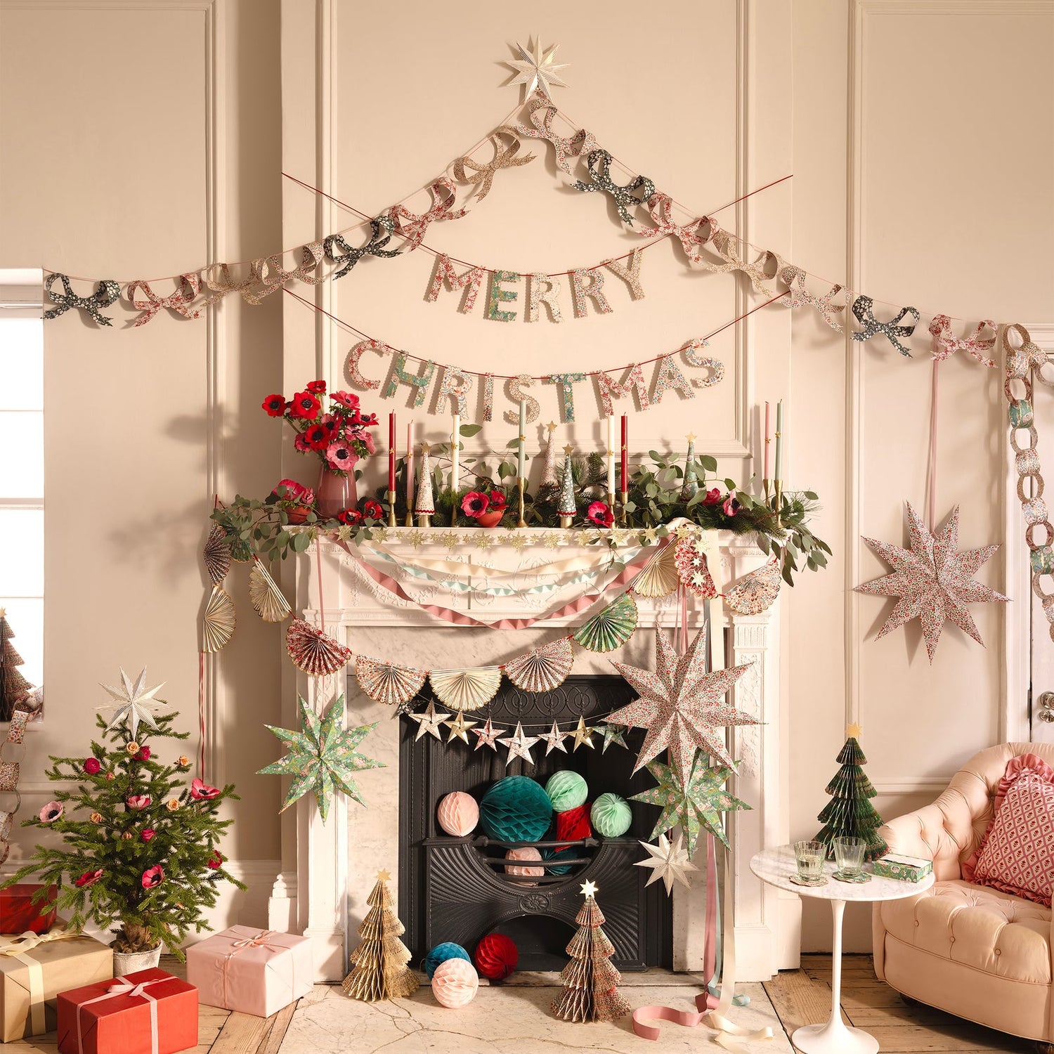 Decorated living room with Christmas decorations, including a fireplace, garlands, and presents.