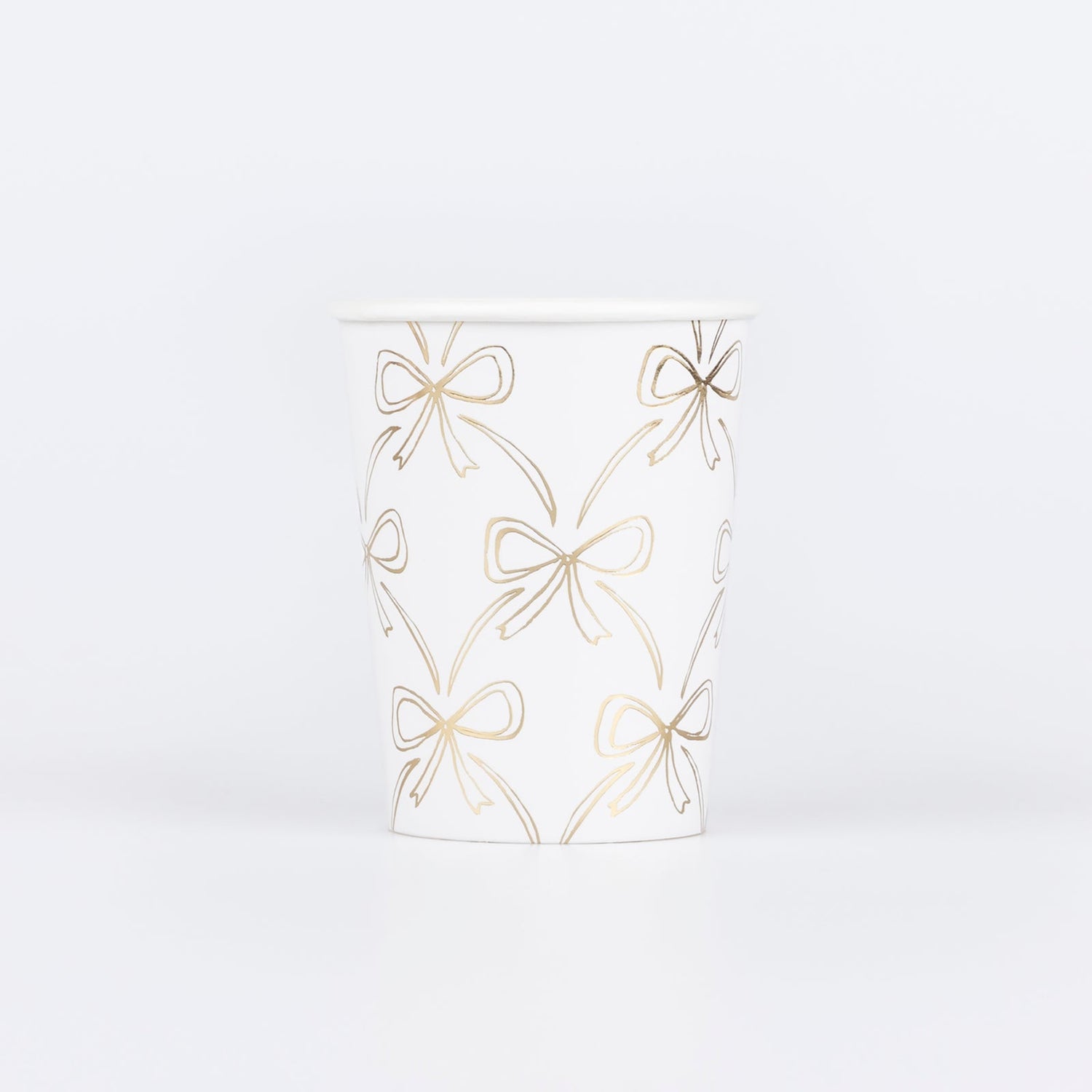 Paper cup by Meri Meri with illustrations of gold bows. 
