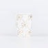 Paper cup by Meri Meri with illustrations of gold bows. 