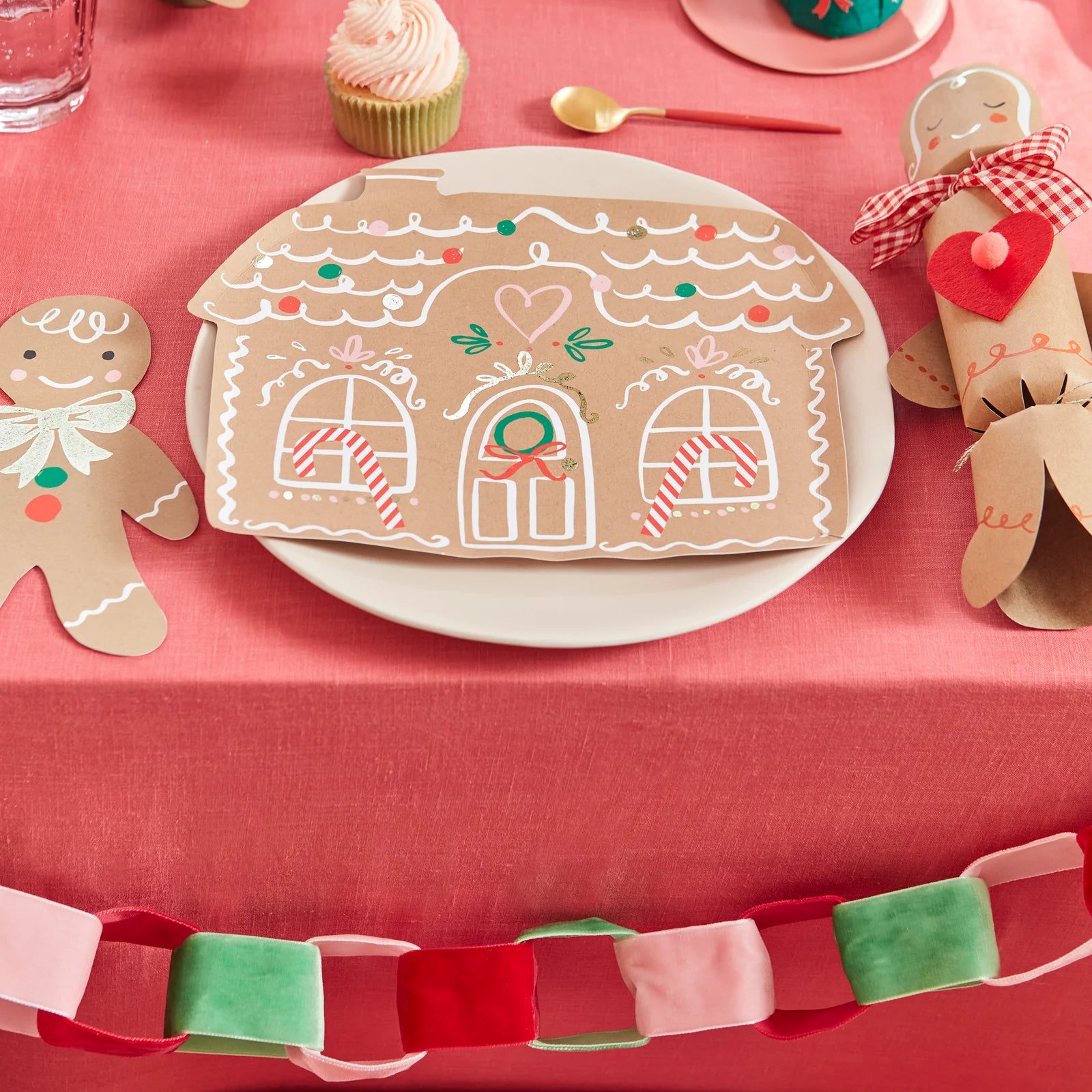 A festive table setting featuring the Gingerbread House Paper Plates, Gingerbread Napkins and Gingerbread Cracker.