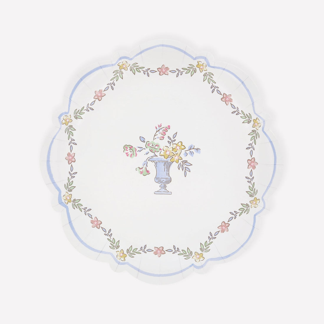 A scalloped paper plate with a chintz-style floral design with a decorative urn at the center.