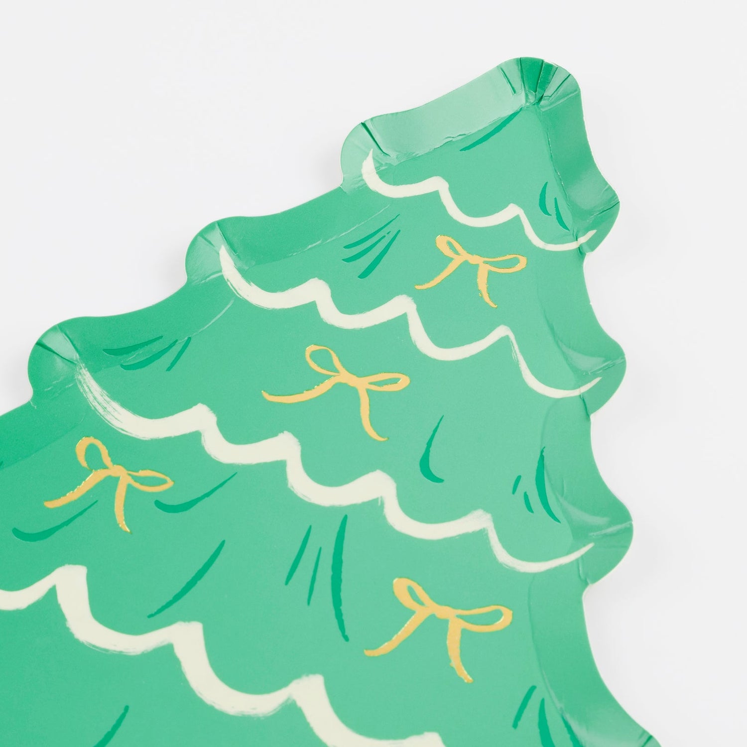 Green paper plate shaped like a Christmas tree with gold ribbons on a white background.