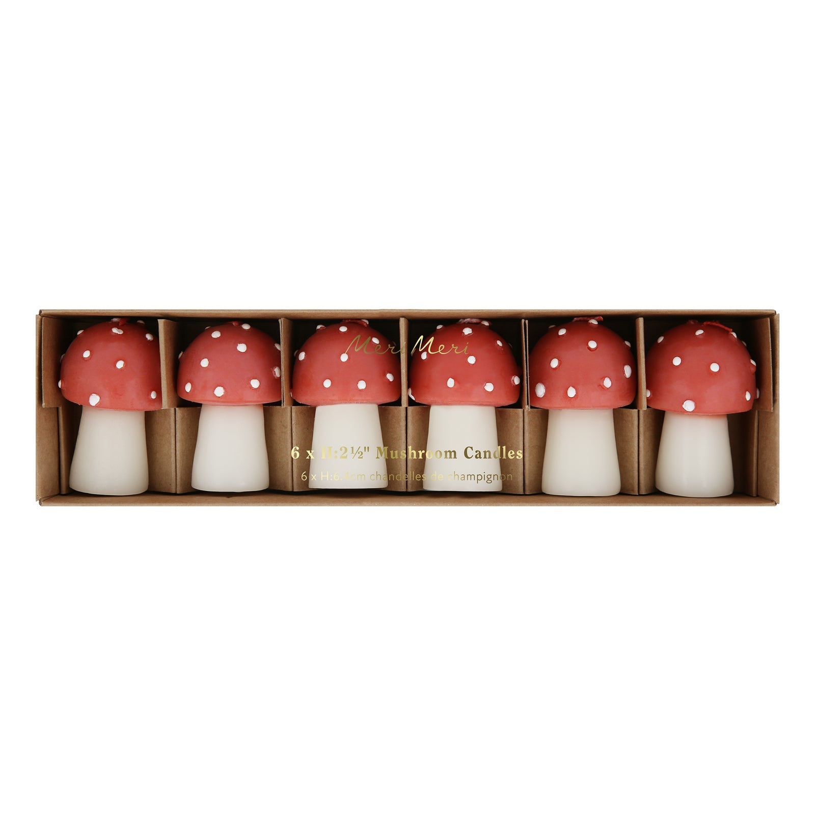 Box of six mushroom-shaped candles with red caps and white spots on a white background.