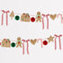 Christmas-themed decorative garland with gingerbread men, houses, and ribbons on a white background.