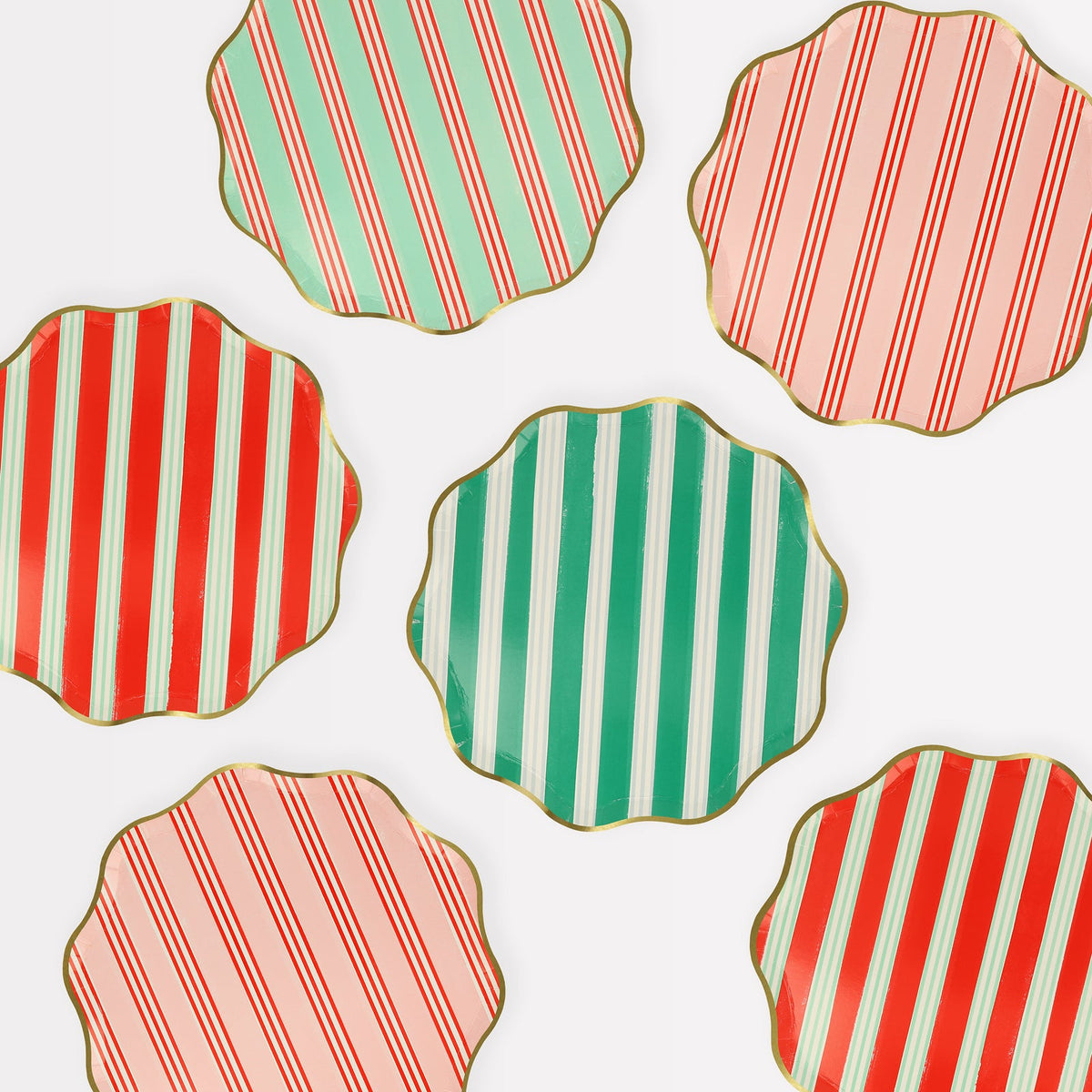 Hexagonal cookies with red, green, and pink striped patterns on a white background