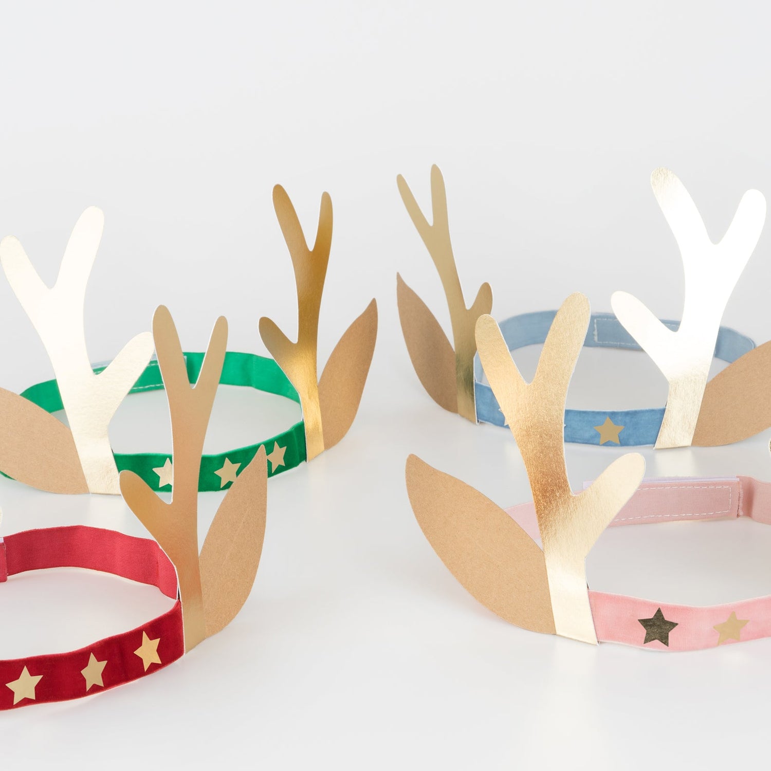 Deer antler headbands with colorful bands on a white background.