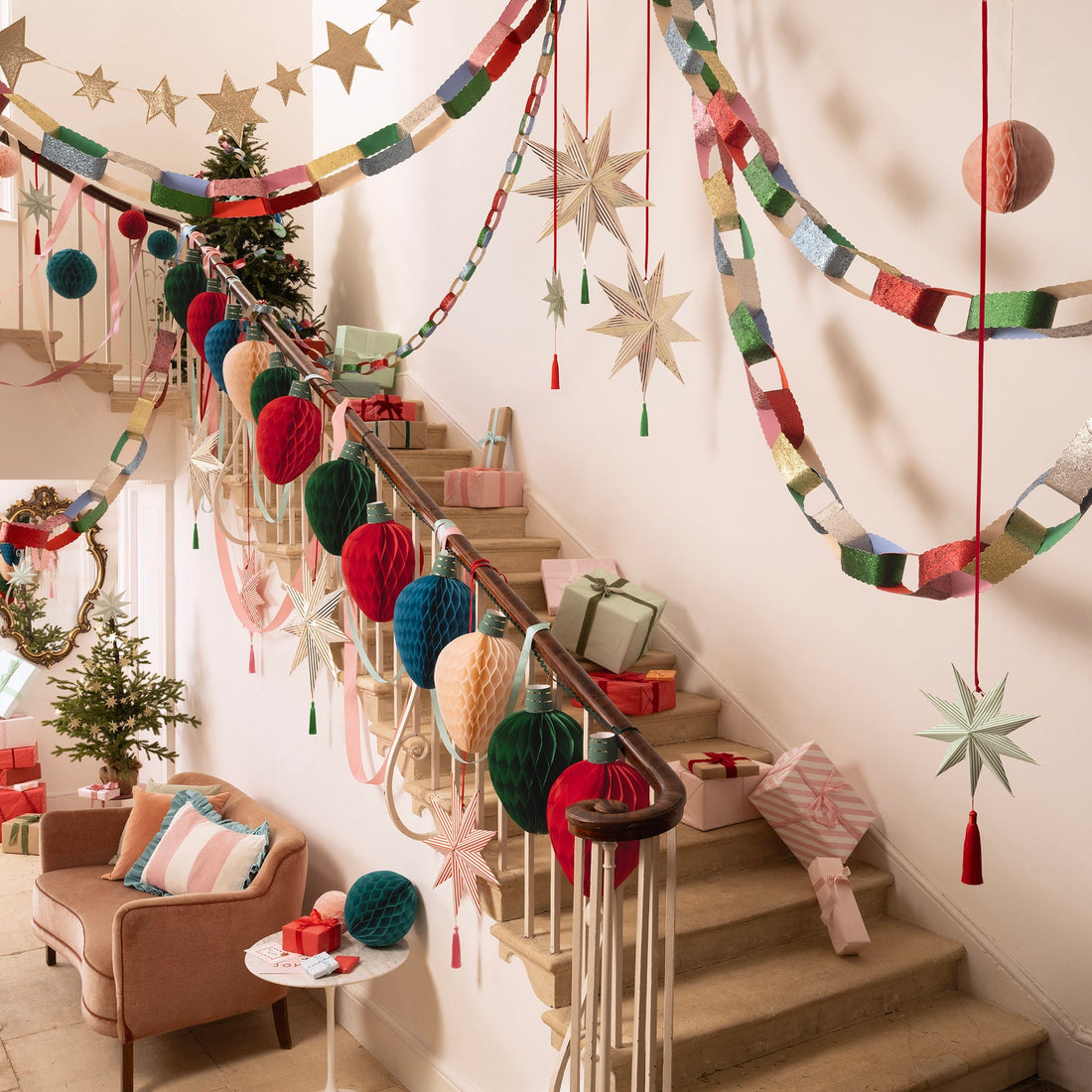 Decorative staircase with colorful yarn pom-poms and star-shaped decorations in a home setting.