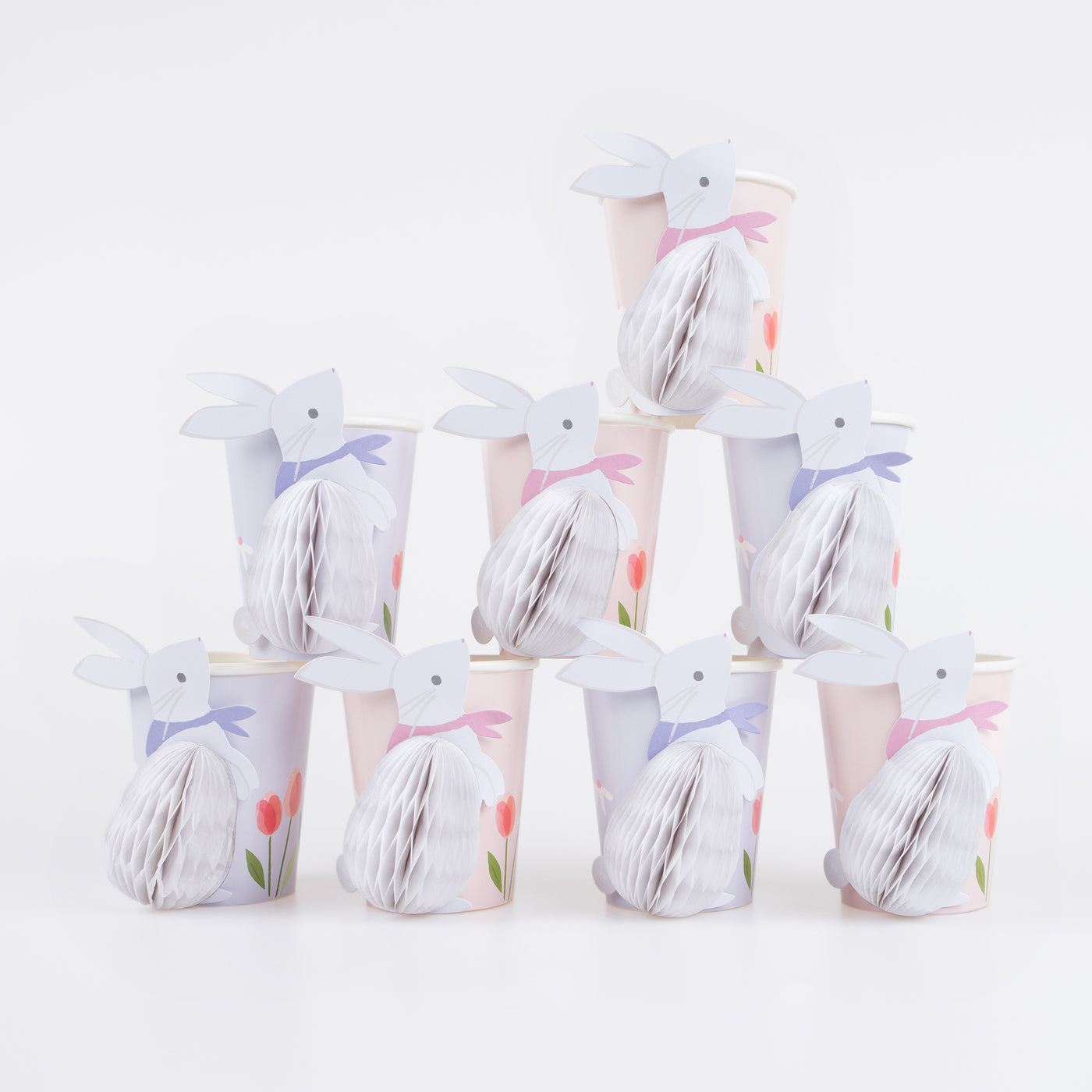 Decorative paper cups with bunny designs on a white background.
