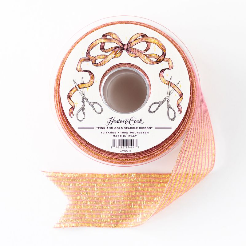 Spool of pink and gold sparkle ribbon by Hester &amp; Cook on a white background