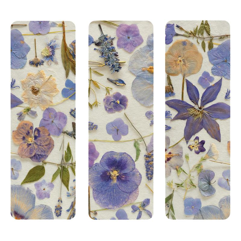Three bookmarks with pressed floral designs on a white background