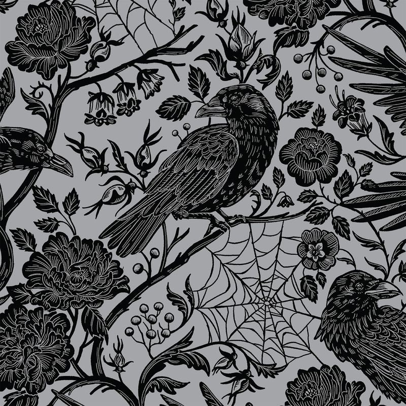 A square cocktail napkin featuring an illustrated pattern of black birds and flowers on a metallic silver background.