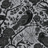A square cocktail napkin featuring an illustrated pattern of black birds and flowers on a metallic silver background.