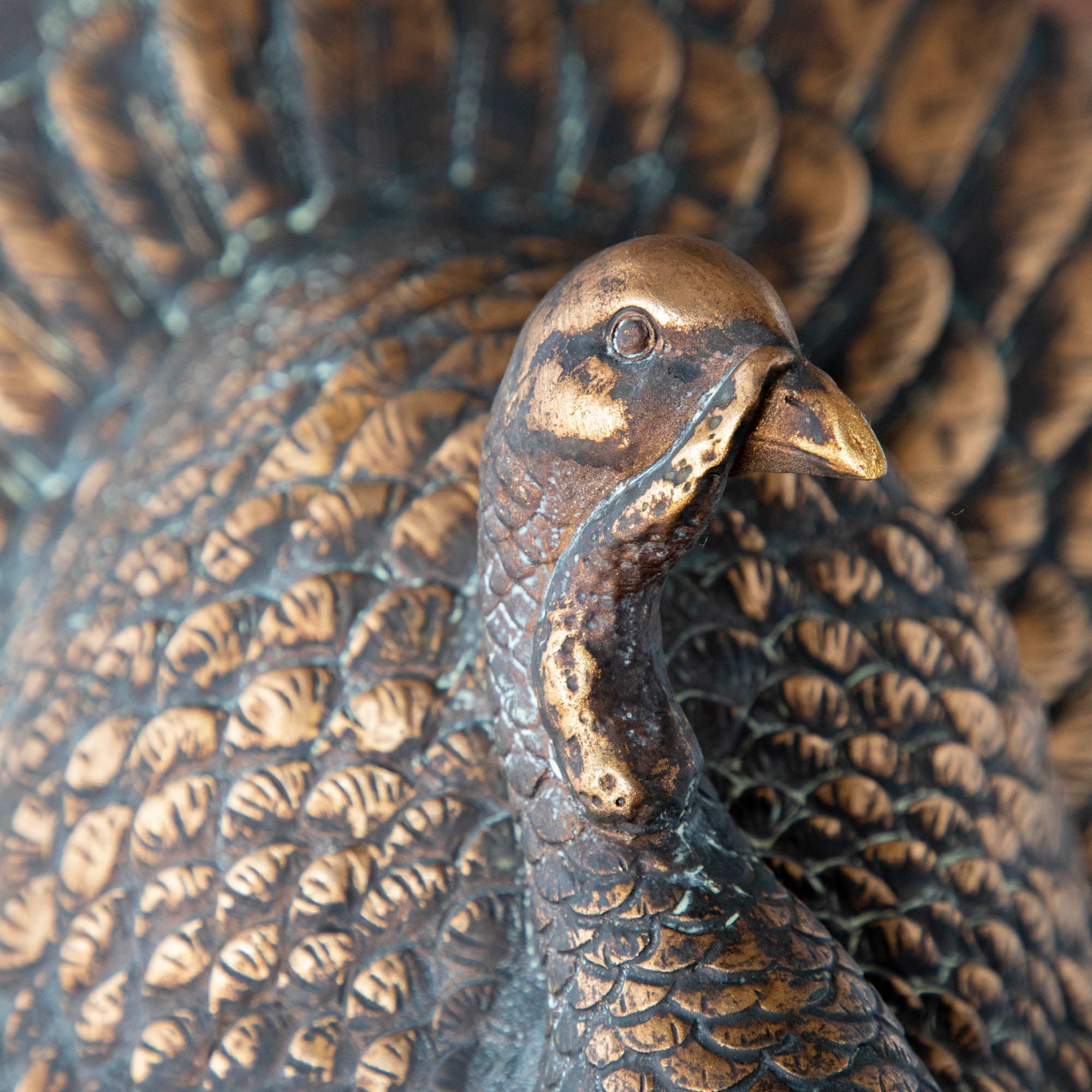 A close up of the Antique Bronzed Turkey showing its rustic look, and detailed carved feathers.