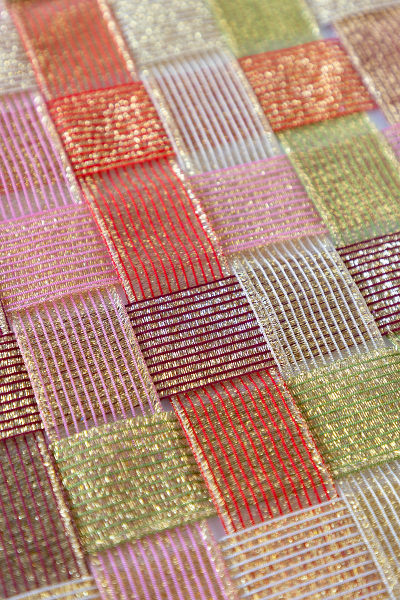 A surface woven with sparkle ribbon in five different colors.