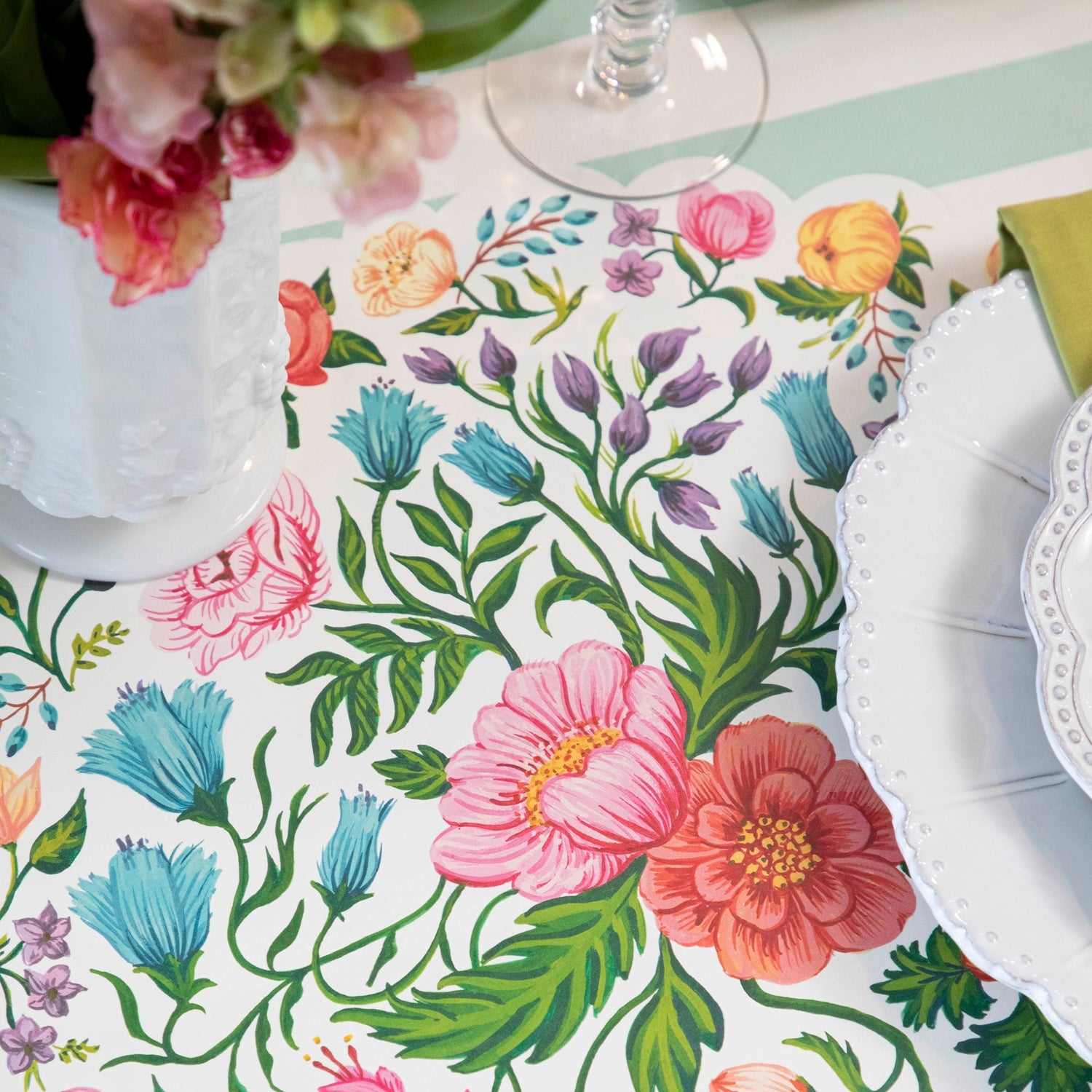 A table setting with Die-cut Sweet Garden Posey Placemats by Hester &amp; Cook and plates.