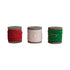 Three spools of ribbon in red, beige, and green on a white background.