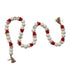 Decorative garland with snowman faces in red hats and jute tassels on a white background.