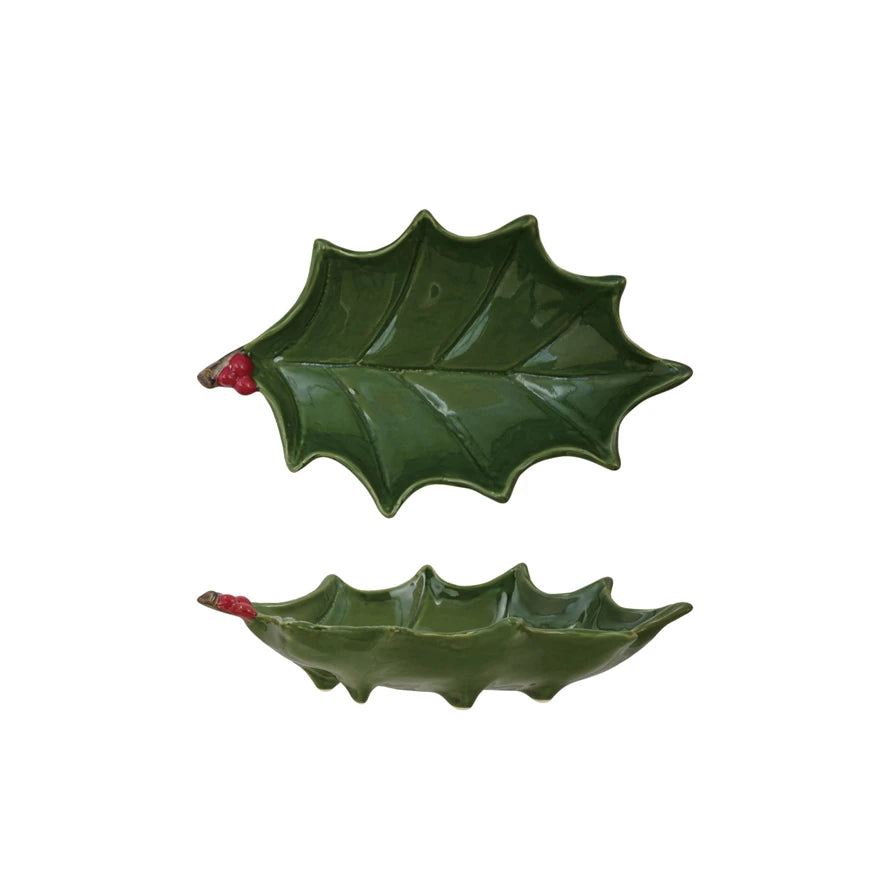Two green holly leaf-shaped dishes on a white background.