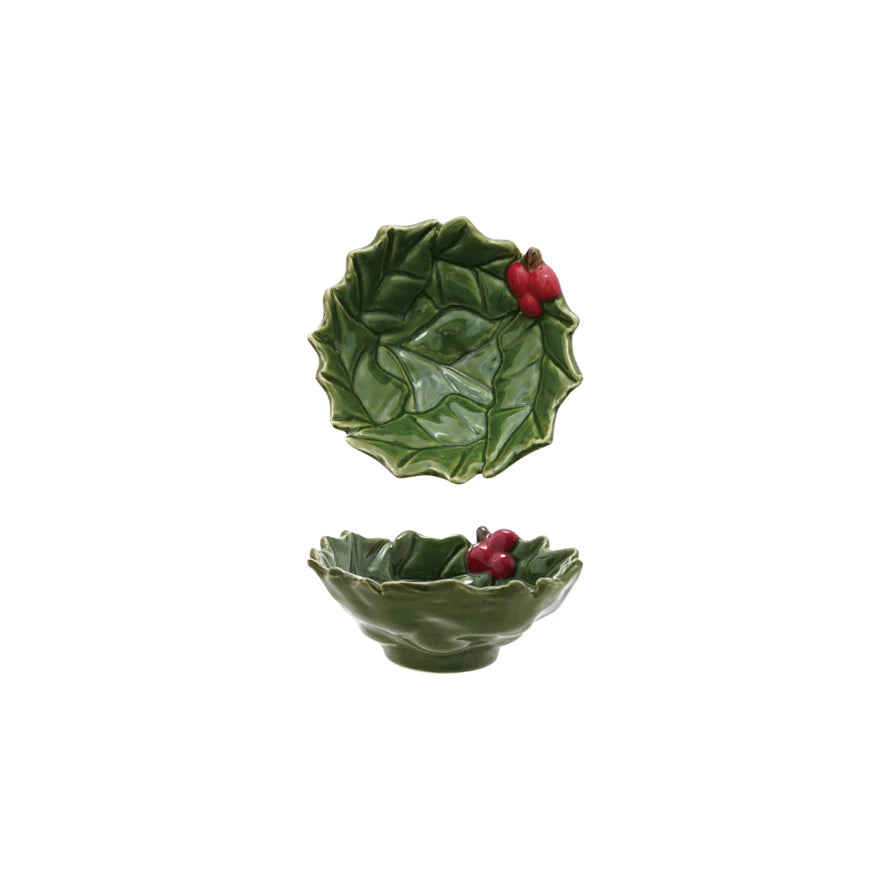 Two green ceramic holly bowls with red berry decorations on a white background.