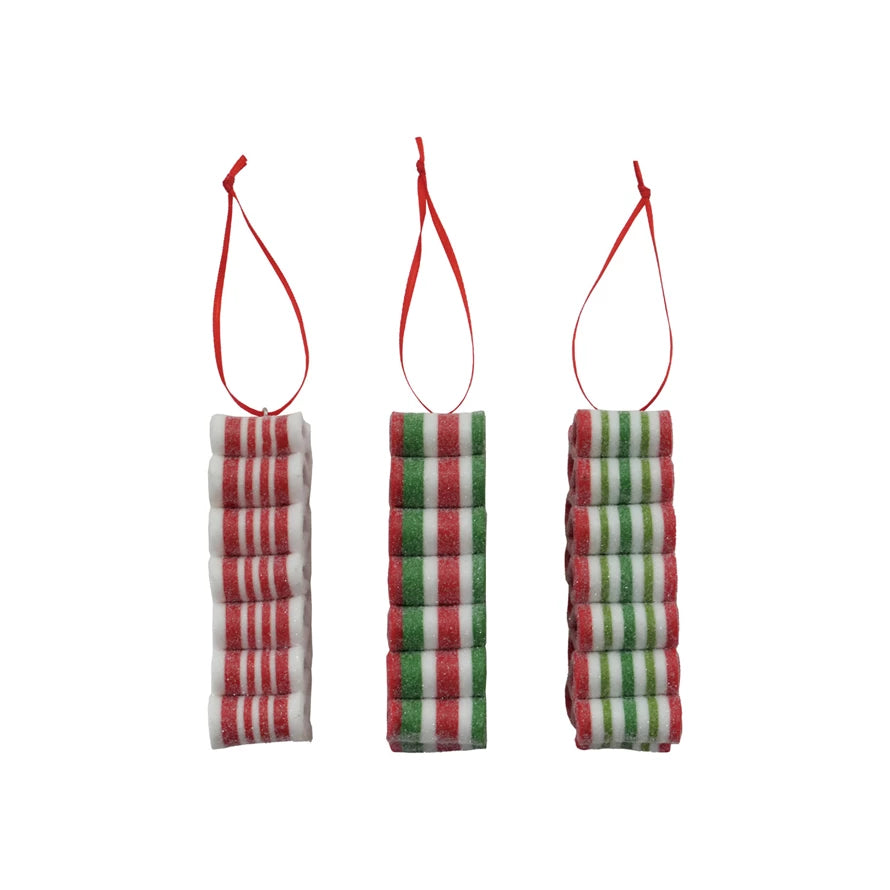 Three Clay Striped Ribbon Candy Ornaments with Glitter with red, green, and white patterns on a white background.