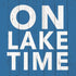 White text reading "On Lake Time" over a blue wooden background, with an image of a Paper Products Design beverage and napkins to the side.