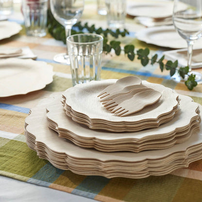 A set of Veneerware Fancy Bamboo Plates and forks by Bambu Wholesale on a table.