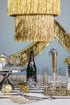 A table with a champagne bottle and glasses, adorned with Meri Meri&