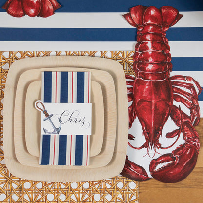 An eco-friendly table setting with Veneerware Square Bamboo Plates made from organic bamboo by Bambu Wholesale, featuring a delicious lobster centerpiece.