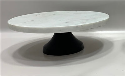 This image features a Marble Footed Cake Plate, showcasing an elegant design suitable for serving and displaying cakes. The plate consists of a smooth, white marble surface, circular in shape, and paired with a contrasting dark, sturdy pedestal base that provides stability.