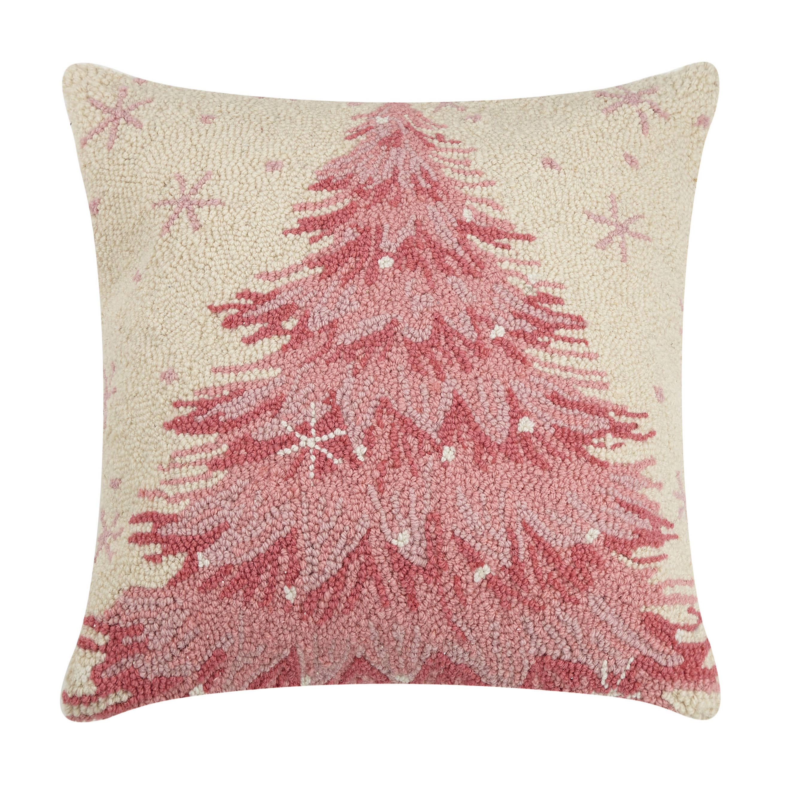 A hooked, pink throw Christmas Tree Holiday pillow with a cream background and pink sparkles.