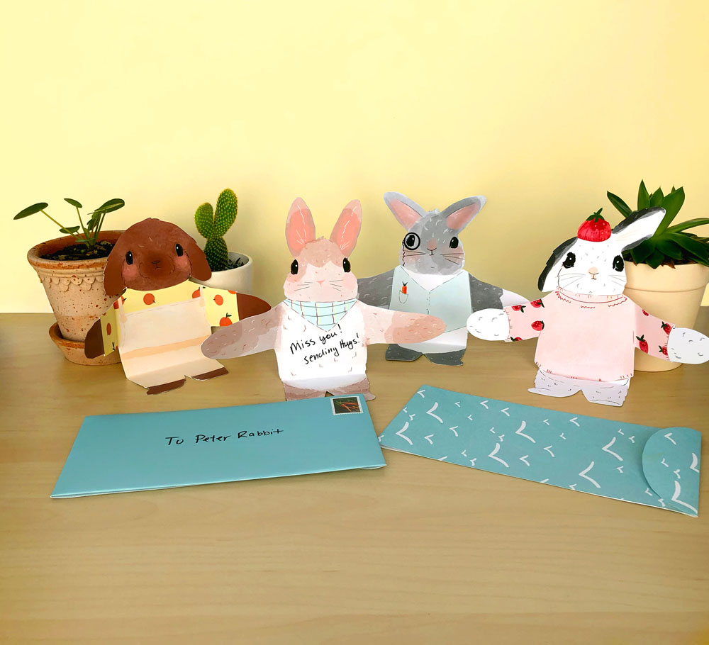 Four open Snuggle Bunny greeting cards on a table.