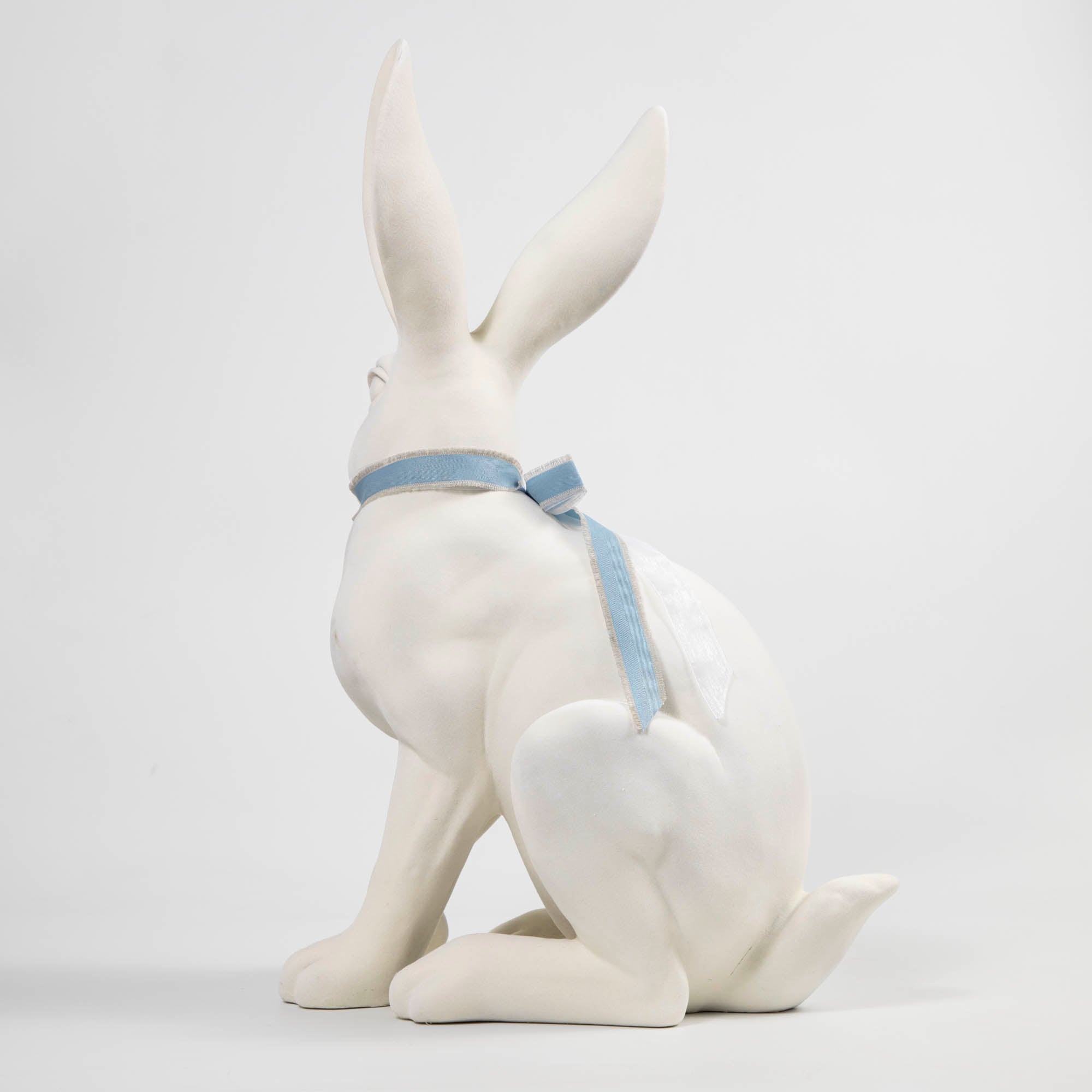 A Flocked Bunny, White &amp; Pink with a blue ribbon around its neck, perfect for Easter decorations from Glitterville.