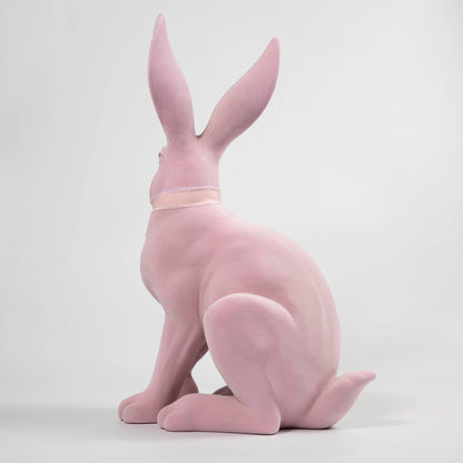 A Glitterville Flocked Bunny, White &amp; Pink statue.
