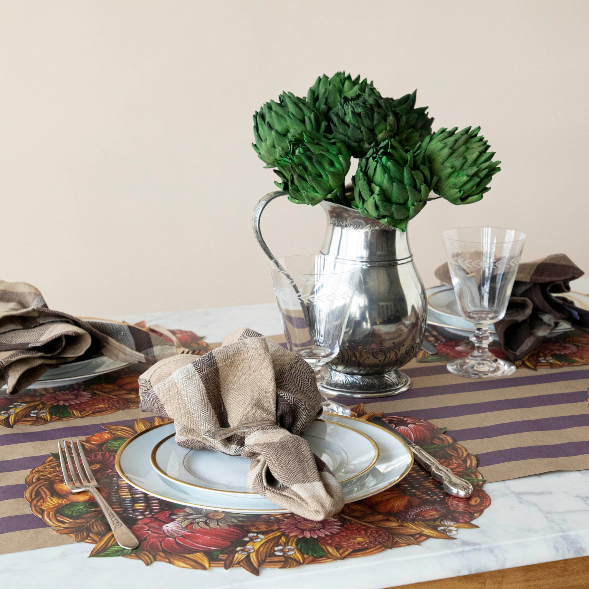 Set table featuring Dried Green Artichokes in silver vase on the table