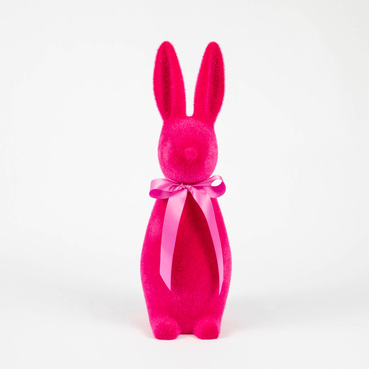 A soft Medium Flocked Button Nose Bunny with a pink bow on a white background from Glitterville.