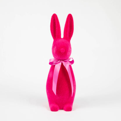 A soft Medium Flocked Button Nose Bunny with a pink bow on a white background from Glitterville.