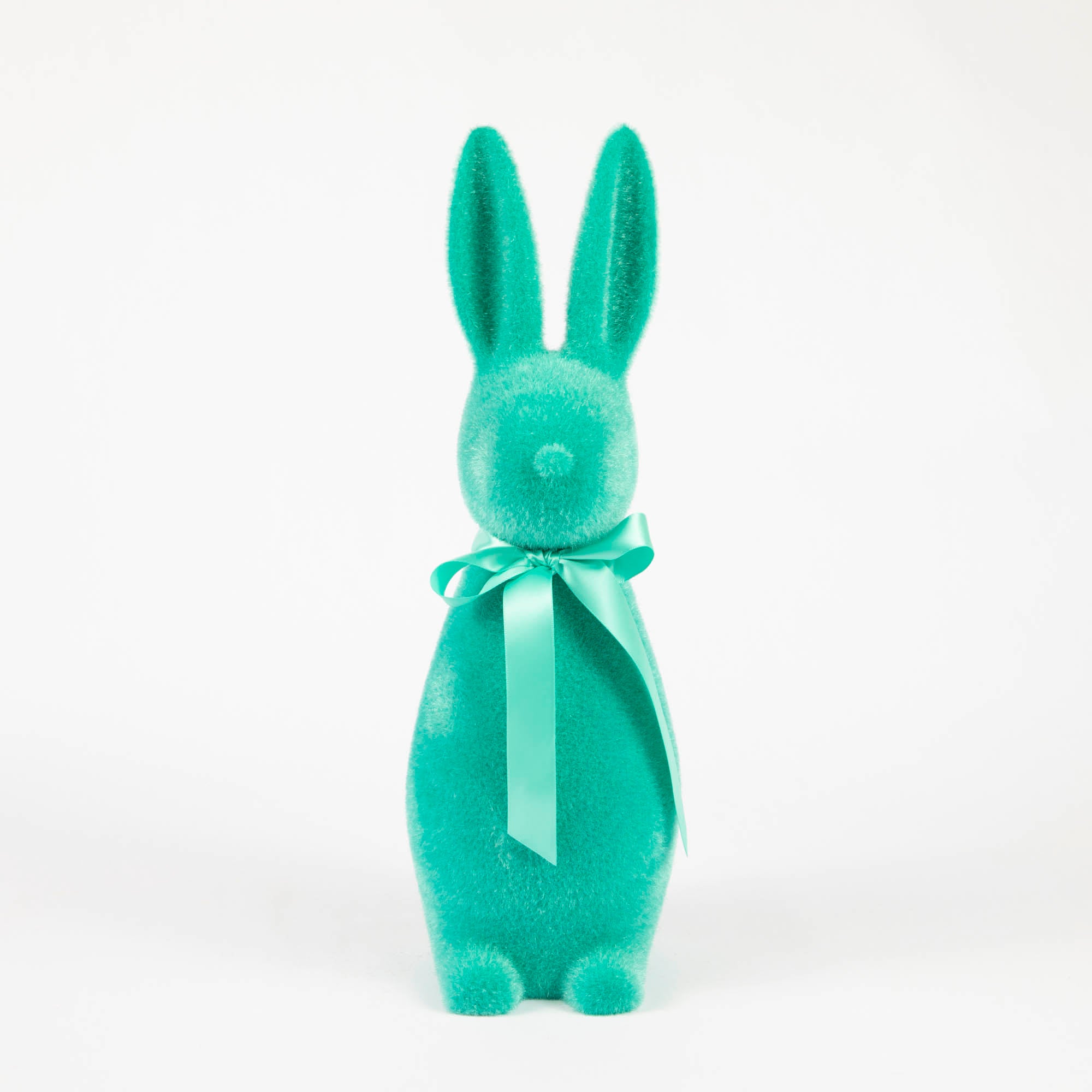 A Medium Flocked Button Nose Bunny by Glitterville, with a bow on a white background, perfect for an Easter celebration.