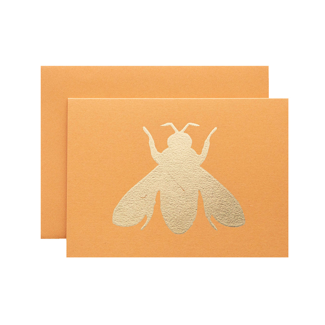 A bright orange card featuring the silhouette of a bee in solid gold leaf.