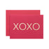 A red card featuring a large "XOXO" in solid gold leaf.