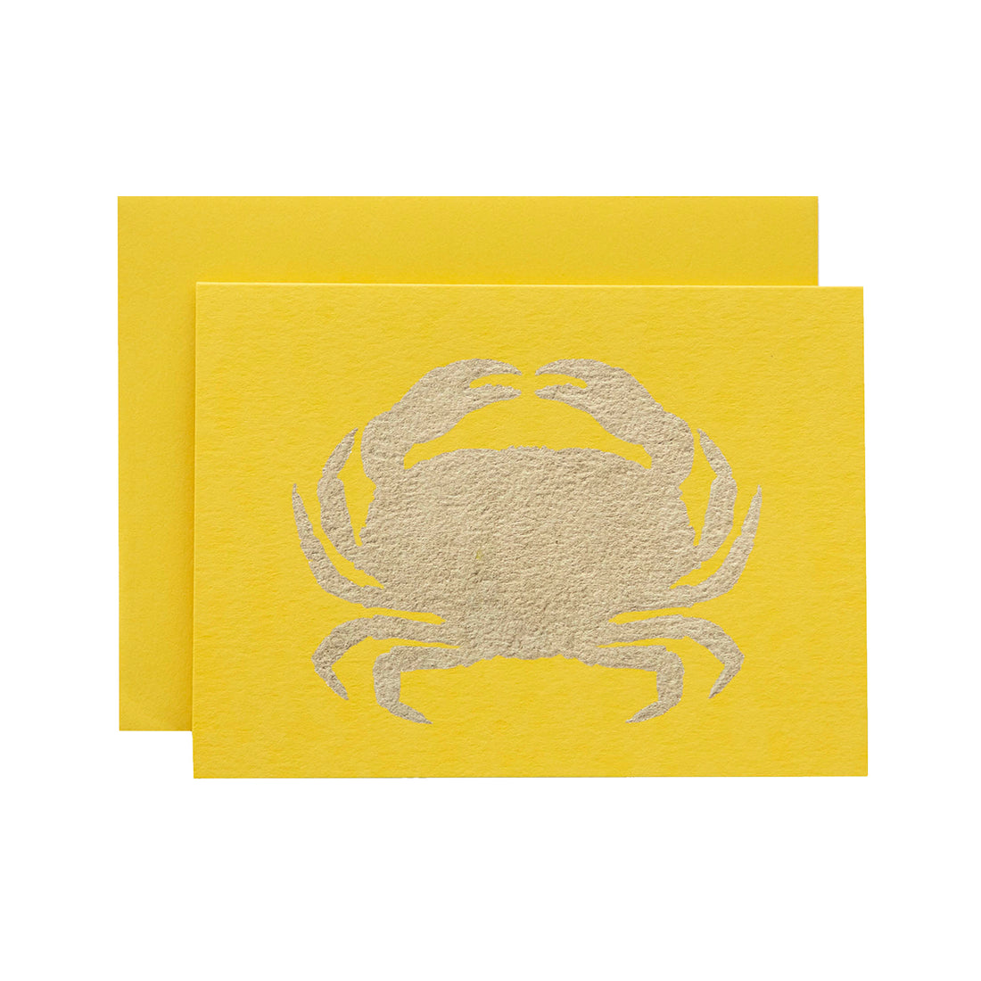A yellow card featuring the silhouette of a crab in solid gold leaf.